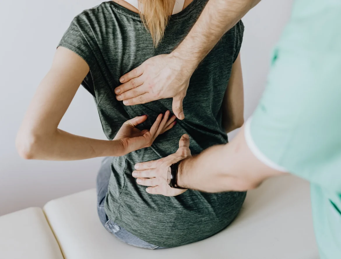 Chiropractor adjusting a young patient’s spine at Boardman Family Chiropractic in Phoenix, Arizona