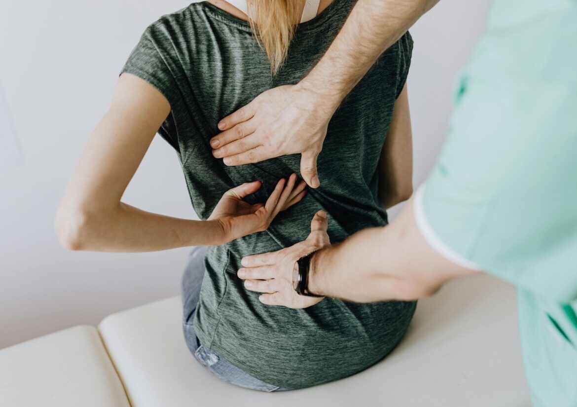 Chiropractor adjusting a patient’s spine to improve posture and mental wellbeing, promoting better mood and reduced stress.