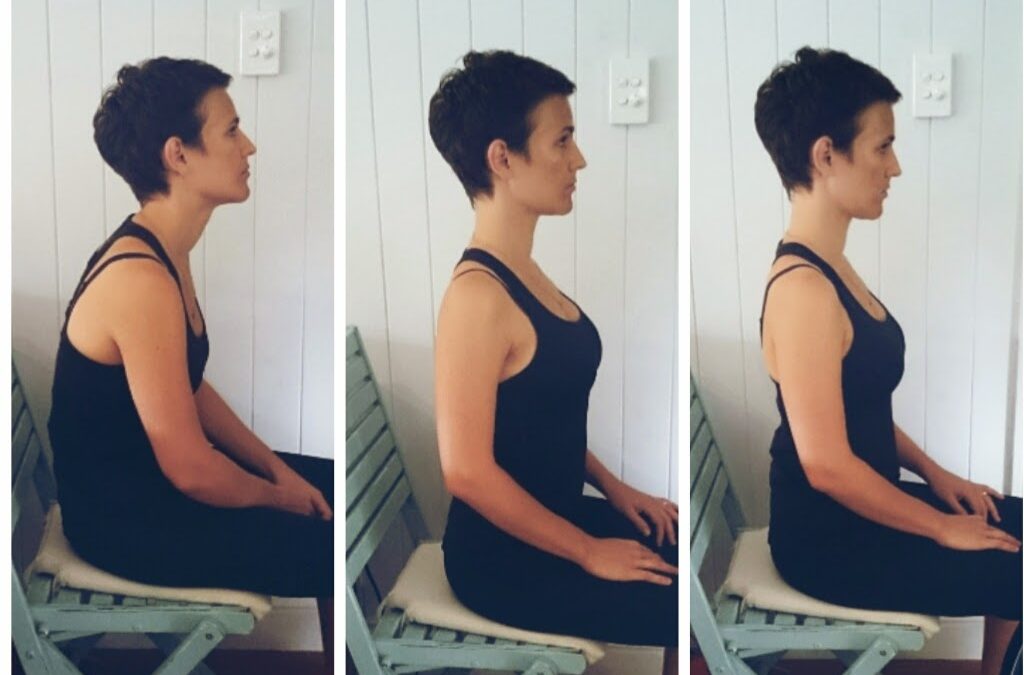 Woman sitting with proper posture at a desk to support spinal health and reduce back pain